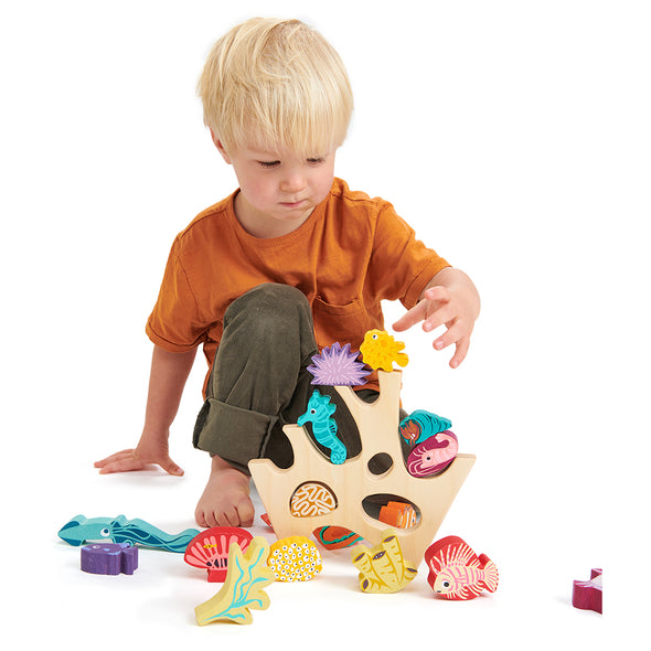 Boy playing with Under the Sea Wooden Toy
