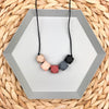 Baby Proof Teething Necklace in black, grey, peach, oatmeal and rust